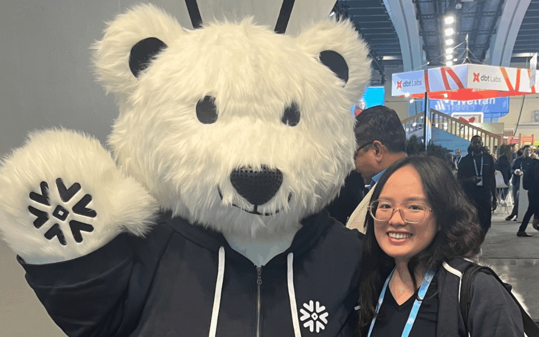 Data consultant, Kathryn, from Data Army posing with the Snowflake bear at Snowflake Summit