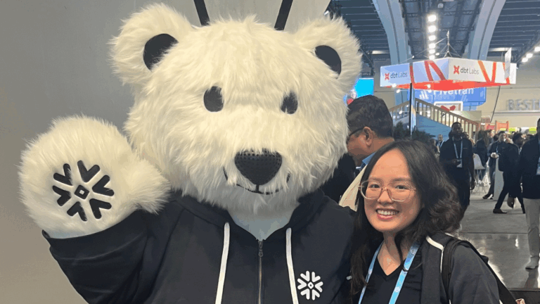 Data consultant, Kathryn, from Data Army posing with the Snowflake bear at Snowflake Summit