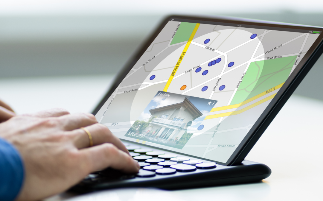 Hands typing on a laptop with screen showing a map zooming into a property and a sale price